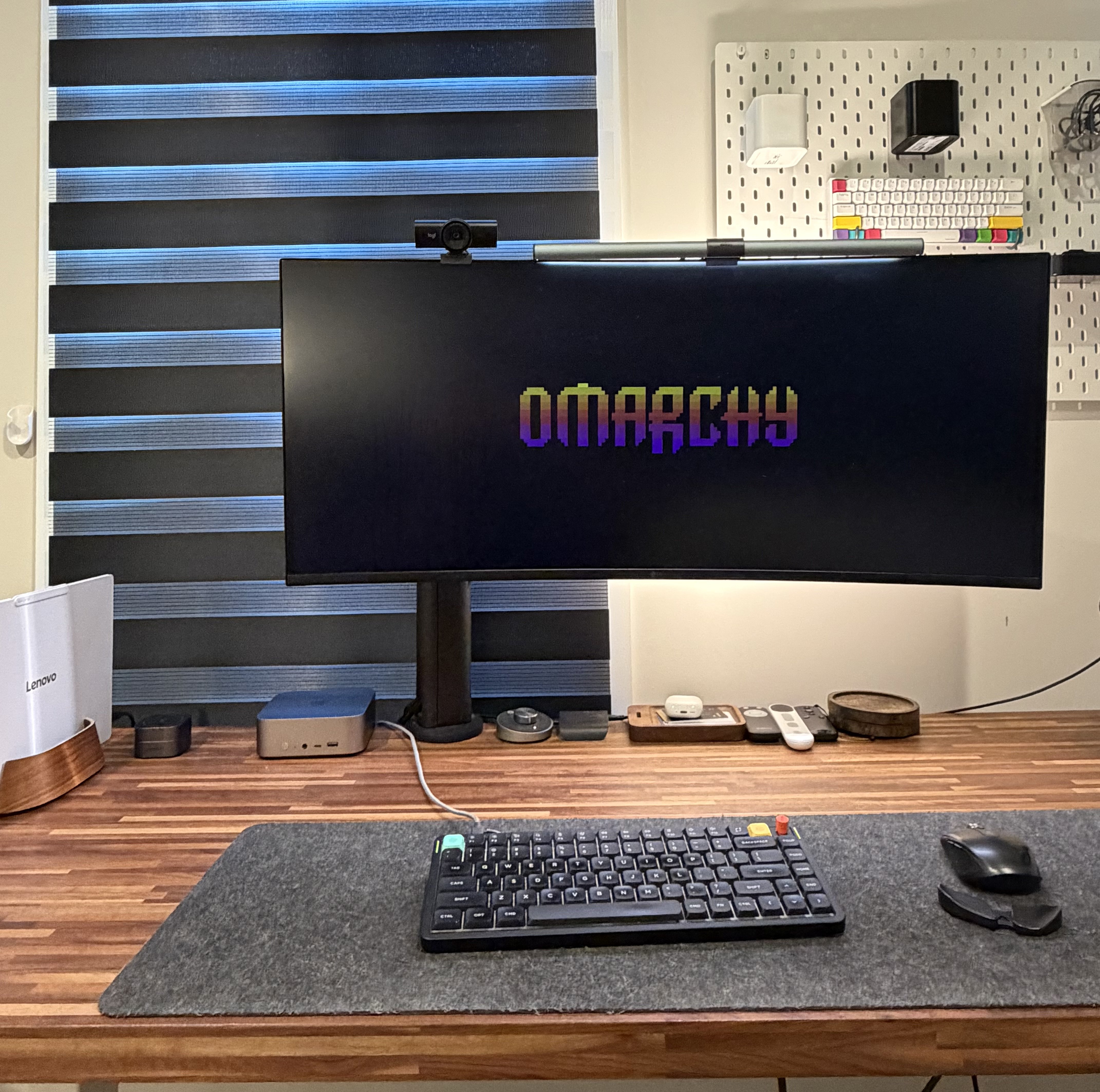 My desk setup with Omarchy on the ultrawide monitor, the Beelink mini desktop, and my Lenovo laptop